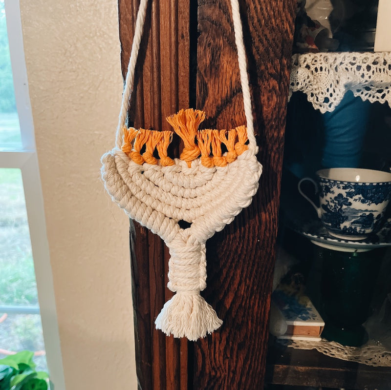 white hanukkah ornament hanging from a display cabinet