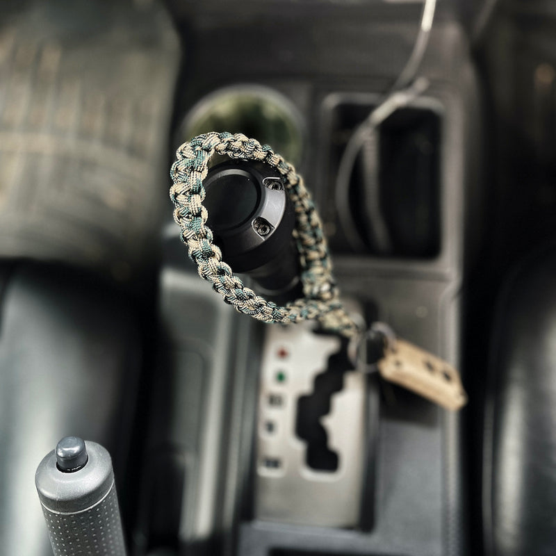 camo wrist keychain from above draped over gearstick