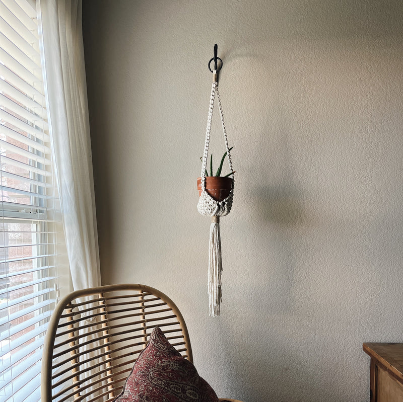 white plant hanger with two accent hemp knots