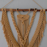 Handmade macrame fiber art wall hanging with intricate knot designs and natural cotton fibers