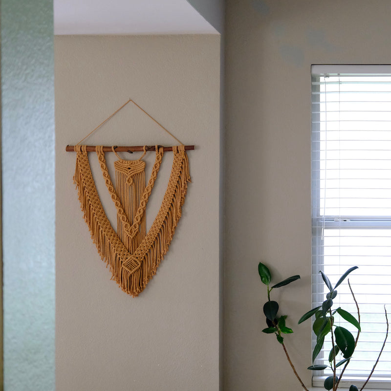 Handmade textile fiber art wall hanging with intricate knot designs and natural cotton fibers