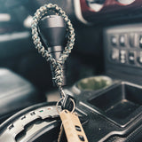 paracord wrist keychain in truck on gear stick