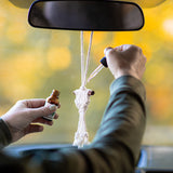 essential oil being dropped onto diffuser in car
