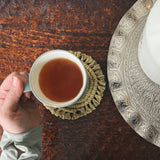 handmade coaster under a cup of tea