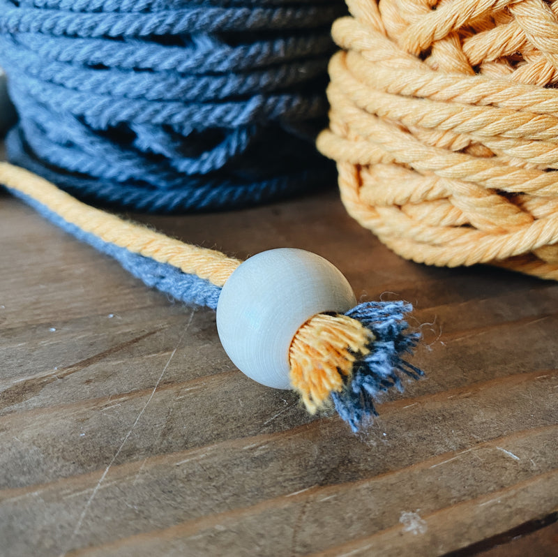 20mm round wood bead shown strong onto 2 macrame twisted cords; each macrame cord is 4mm thick