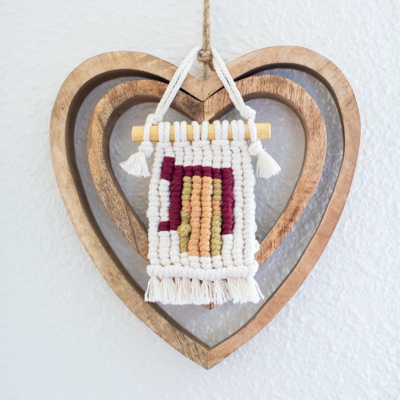 Pesach gift hung in front of heart wall decor