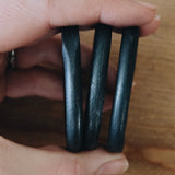 3 rings held in a hand, showing the 2 inch diameter